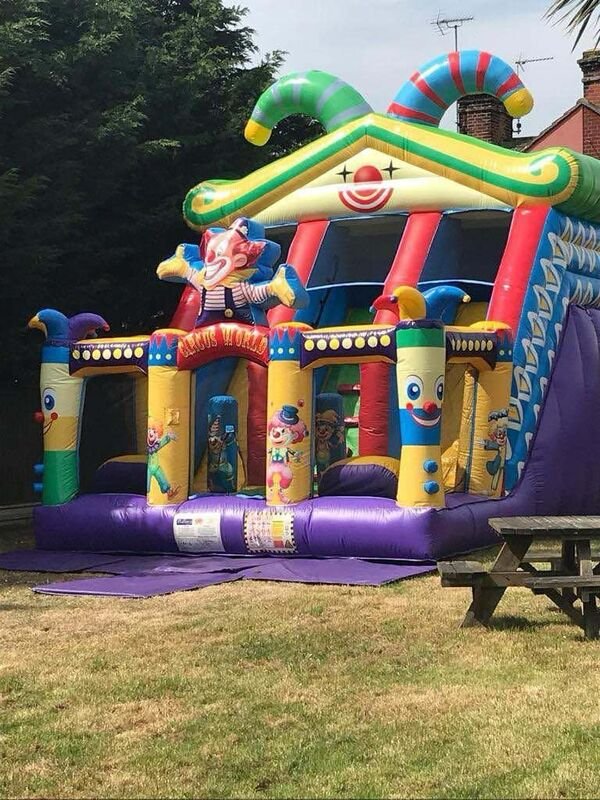 Premium clown slide bouncy castle - Large inflatable with slide for bigger parties in Clacton-on-Sea